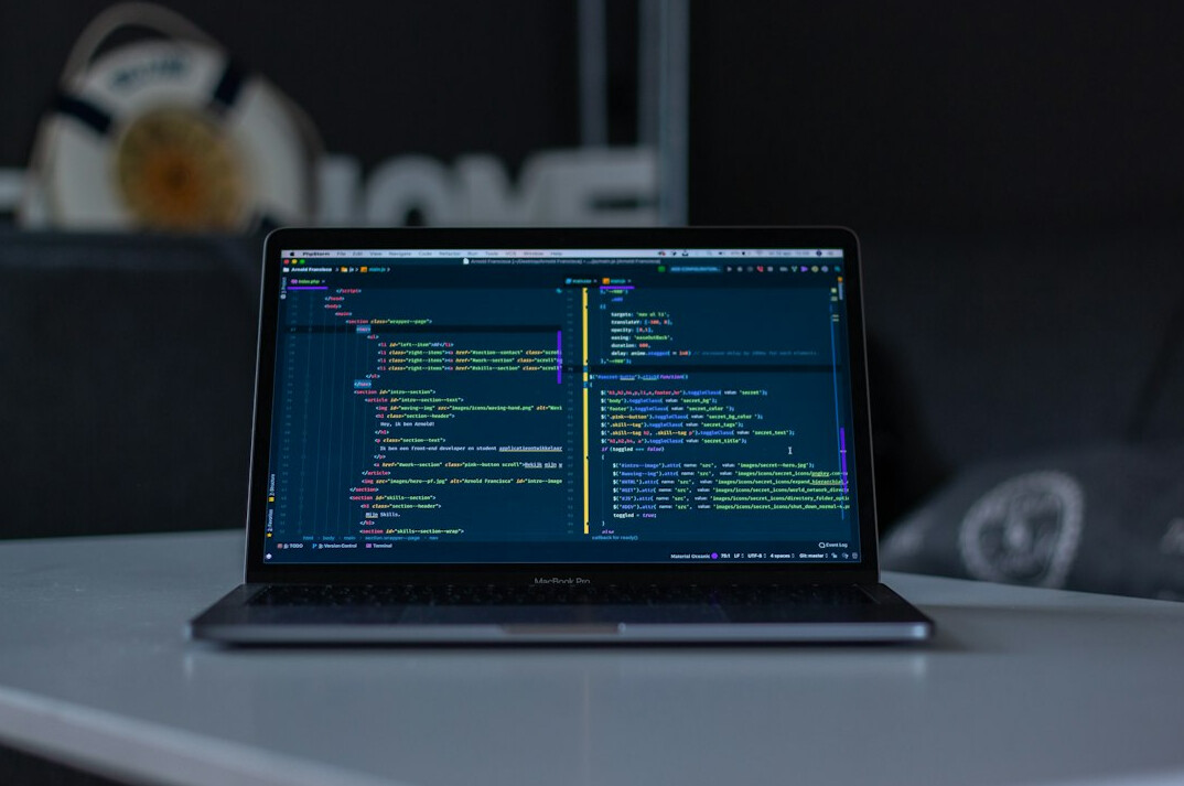 person coding on laptop