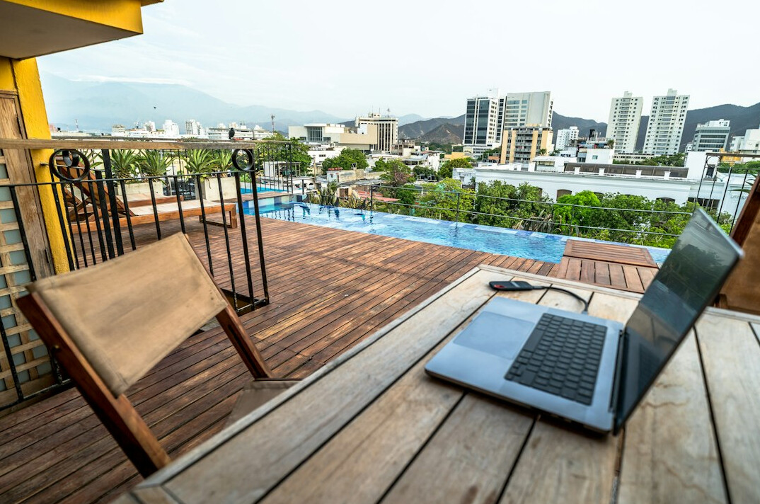 remote worker with laptop on balcony